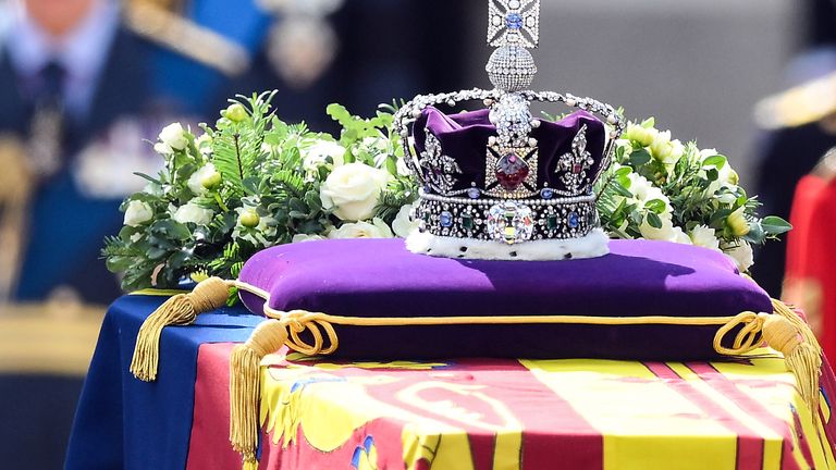 The coffin of Queen Elizabeth II, draped in the Royal Standard with the Imperial State Crown placed on top, is carried on a horse-drawn gun carriage of the King&#39;s Troop Royal Horse Artillery, during the ceremonial procession from Buckingham Palace to Westminster Hall, London, where it will lie in state ahead of her funeral on Monday. Picture date: Wednesday September 14, 2022.
