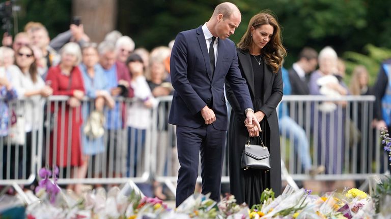 The Prince and Princess of Wales view floral tributes left by members of the public at the gates of Sandringham House in Norfolk, following the death of Queen Elizabeth II. Picture date: Thursday September 15, 2022.