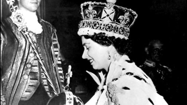 FILE - In this June 2, 1953 file photo, Britain&#39;s Queen Elizabeth II wearing the bejeweled Imperial Crown and carrying the Orb and Scepter with Cross, leaves Westminster Abbey, London, at the end of her coronation ceremony. On Monday Feb. 6, 2017, Queen Elizabeth II marks her Sapphire Jubilee, becoming the first British monarch to reign for 65 years. (AP Photo/File)
