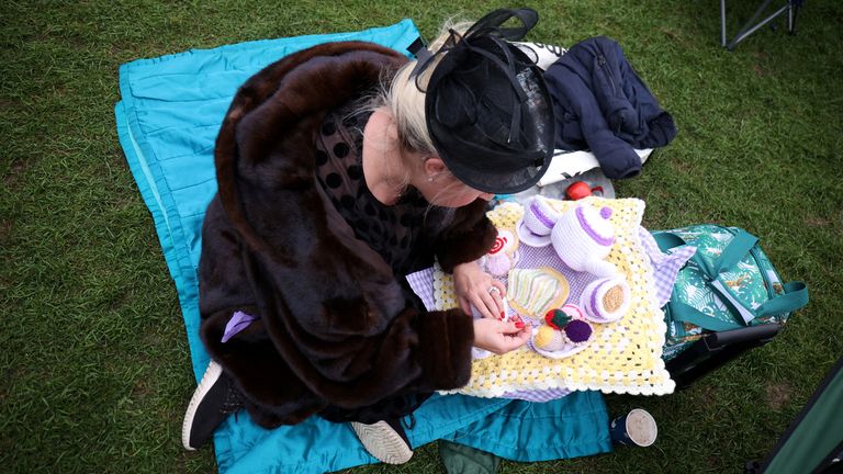 A well-wisher has been knitting to pass the time during a long wait at the Long Walk in Windsor. The State Hearse carrying the Queen will arrive in the Berkshire town shortly after 3pm.