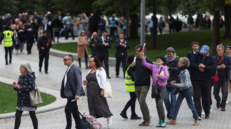 A person reacts in a queue as people gather to pay their respects to Britain's Queen Elizabeth after her death, at South Bank, London, Britain September 15, 2022. REUTERS / Tom Nicholson