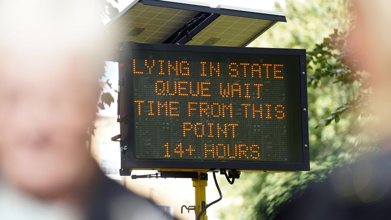 A sign in London's Southwark Park informing the public that there is more than 14 hours in line to see Queen Elizabeth II lying in state ahead of her funeral on Monday.  Image date: Friday September 16, 2022.