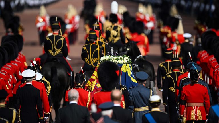 The coffin of Queen Elizabeth II, draped in the Royal Standard with the Imperial State Crown placed on top, is carried on a horse-drawn gun carriage of the King&#39;s Troop Royal Horse Artillery, during the ceremonial procession from Buckingham Palace to Westminster Hall, London, where it will lie in state ahead of her funeral on Monday. Picture date: Wednesday September 14, 2022.
