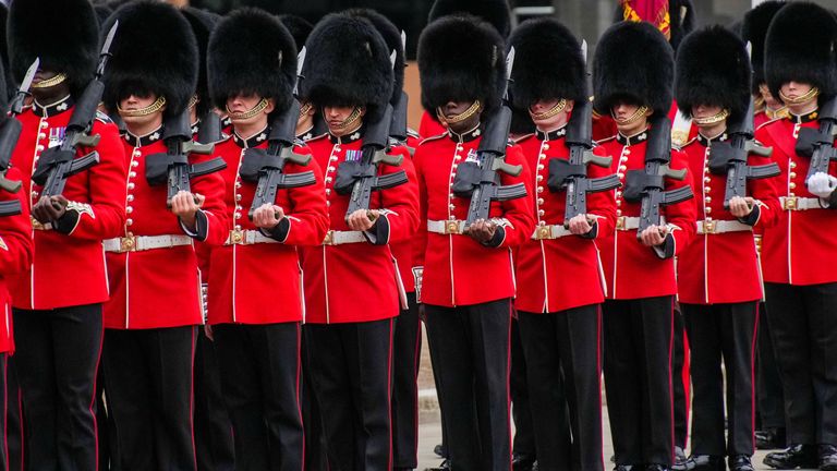 Royal Guards react ahead of the funeral service for Queen Elizabeth II in central London Monday Sept. 19, 2022.The Queen, who died aged 96 on Sept. 8, will be buried at Windsor alongside her late husband, Prince Philip, who died last year. Emilio Morenatti/Pool via REUTERS
