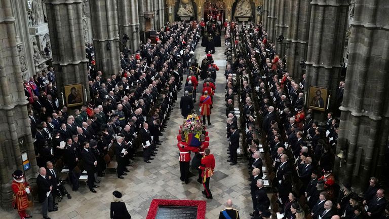 The coffin of Queen Elizabeth II is carried into Westminster Abbey for her funeral in central London, Monday, Sept. 19, 2022. The Queen, who died aged 96 on Sept. 8, will be buried at Windsor alongside her late husband, Prince Philip, who died last year. Frank Augstein/Pool via REUTERS