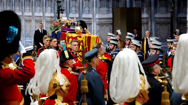 LONDON, ENGLAND - SEPTEMBER 19: The coffin of Queen Elizabeth II with the Imperial State Crown resting on top is carried into Westminster Abbey during the State Funeral of Queen Elizabeth II on September 19, 2022 in London, England.