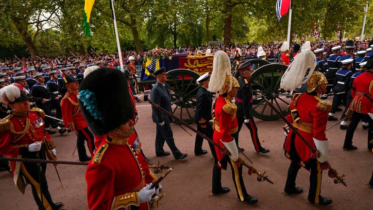 The coffin of Queen Elizabeth II is pulled following her funeral service in Westminster Abbey in central London, Monday, Sept. 19, 2022. The Queen, who died aged 96 on Sept. 8, will be buried at Windsor alongside her late husband, Prince Philip, who died last year. (AP Photo/Andreea Alexandru, Pool)