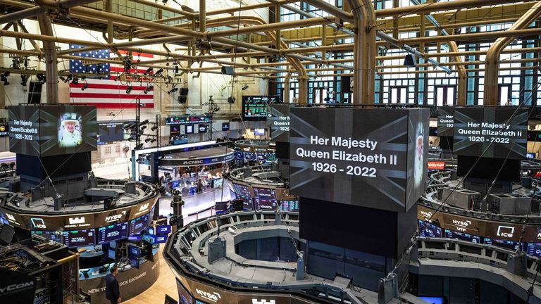 Brokers stand on the floor of the New York Stock Exchange during a moment of silence. Pic: AP