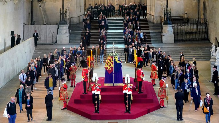 Members of the filing public walk past the coffin of Queen Elizabeth II, dressed in Royal Standard with the Crown of the Royal State and the orb and scepter of the Sovereign, located in the upper state. catafalque in Westminster Hall, at the Palace of Westminster, London, ahead of her funeral on Monday.  Date taken: Thursday, September 15, 2022.