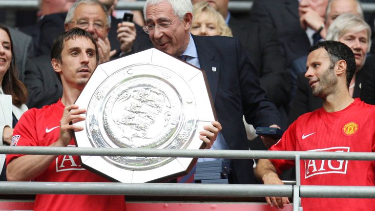 Football - Manchester United v Portsmouth FA Community Shield - Wembley Stadium - 10/8/08 Captain Gary Neville (L) of Manchester United lifts the FA Community Shield as Ryan Giggs (2nd R), Geoff Hurt (R) and FA Chairman Lord Triesman (C) look on Mandatory Credit: Action Images / Carl Recine Livepic
