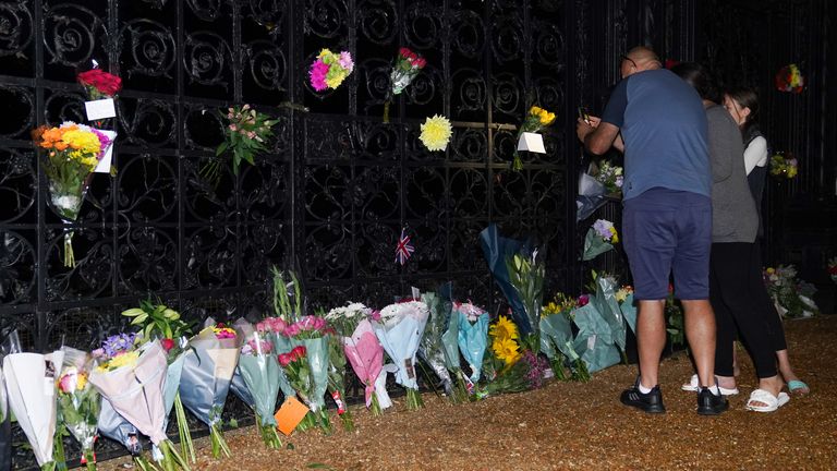 People lay flowers and pay their respects at the gate of Sandringham House on the Sandringham estate in Norfolk