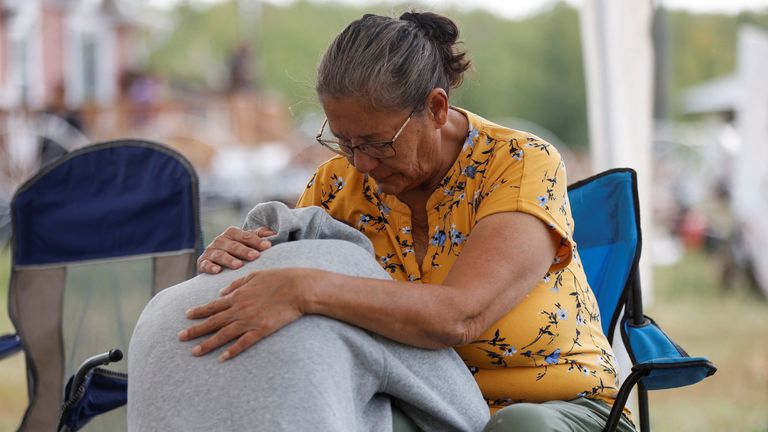Annie Sanderson comforts her granddaughter, who was close with Gloria Lydia Burns, 62, who was killed on James Smith Cree Nation after a stabbing spree killed 10 people on the reserve and nearby town of Weldon, Saskatchewan, Canada. September 5, 2022. REUTERS/David Stobbe