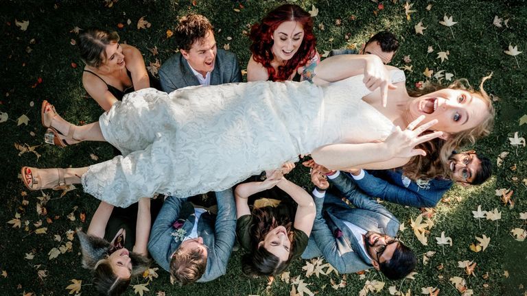 Siena Awards: Drone Photo Awards 2022.
WEDDING: Highly commended
I&#39;m Married!  by Wenyuan Kuang 
After the bridal party shoot was all done and dusted, the photographer added something a little different to the gallery. Initially wanting to toss the groom up but decided it would be more fun to do it with the bride this time. And so here is the flying bride portrayed with the party guests and then framed by a field of autumn leaves.
