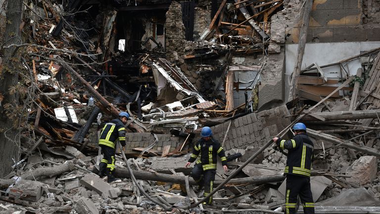 A firefighter works after a Russian attack that heavily damaged a building in Sloviansk, Ukraine, Tuesday, Sept. 27, 2022. (AP Photo/Andriy Andriyenko)