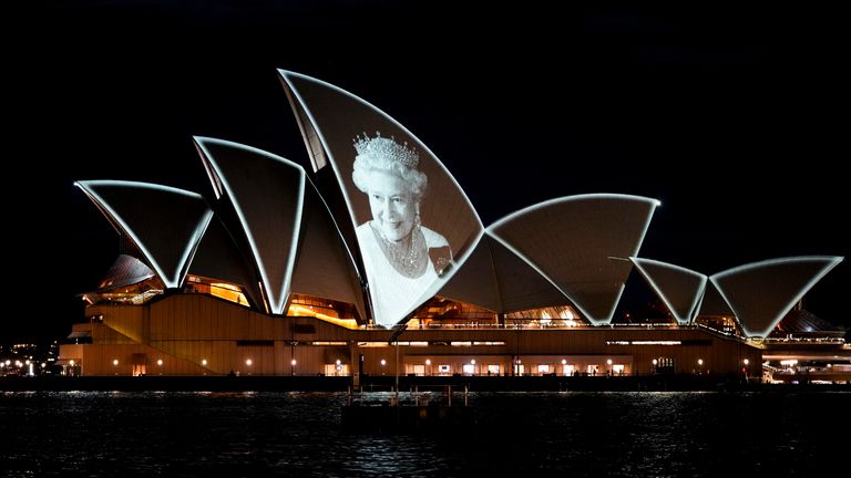 The Sydney Opera House is lit up with a portrait of Queen Elizabeth II in Sydney, Australia, Friday, Sept. 9, 2022. Queen Elizabeth II, Britain's longest-reigning monarch and a rock of stability in a turbulent time for this country and the world, died on Thursday 8 September after 70 years on the throne.  He was 96. (AP Photo/Mark Baker)