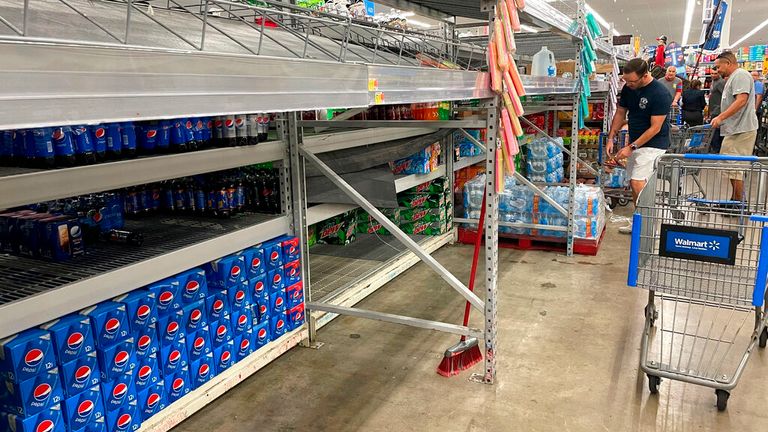 Empty shelves drained from a supermarket in Tampa, Fla. Photo: Tampa Bay Times/AP 