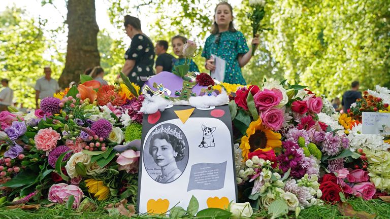 Members of the public lay memorial flowers in Green Park, near Buckingham Palace, London.  Queen Elizabeth II's coffin is traveling from Balmoral to Edinburgh, where it will rest at Holyroodhouse Palace.  Date taken: Sunday, September 11, 2022.