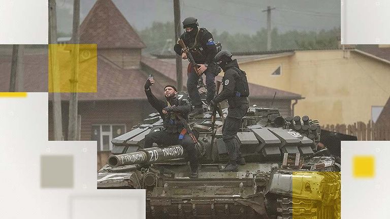 Police in Ukraine take pictures on a captured tank. 