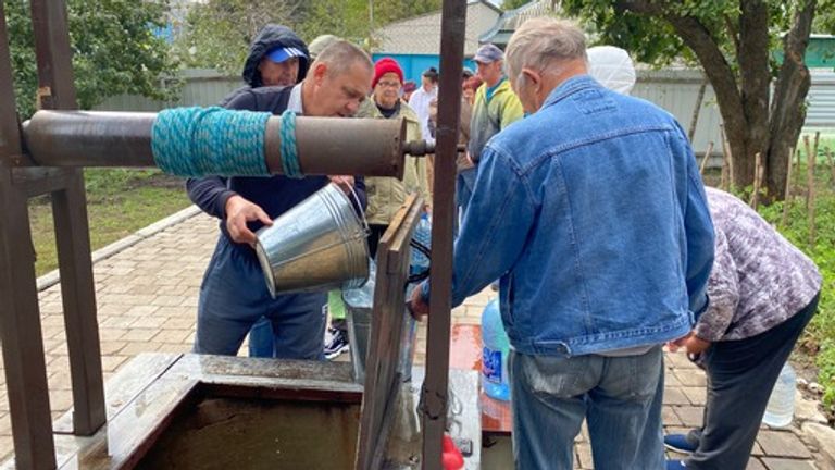 Villagers queue for water in Kupiansk, Ukraine