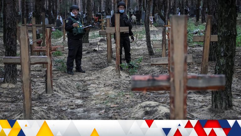Police work at a mass burial site during an exhumation, as Russia&#39;s attack on Ukraine continues, in the town of Izium, recently liberated by Ukrainian Armed Forces, in Kharkiv region, Ukraine September 16, 2022.  REUTERS/Gleb Garanich