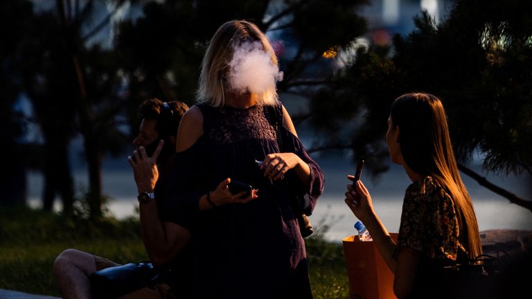 Women vape in the Moscow International Business Center, also known as Moscow-City, on a sunny day in Moscow, Russia August 12, 2022. REUTERS/Maxim Shemetov