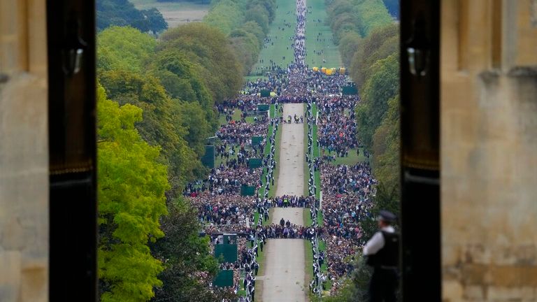 Members of the public line the Long Walk after the coffin of Queen Elizabeth II arrived at Windsor Castle. Pic: AP