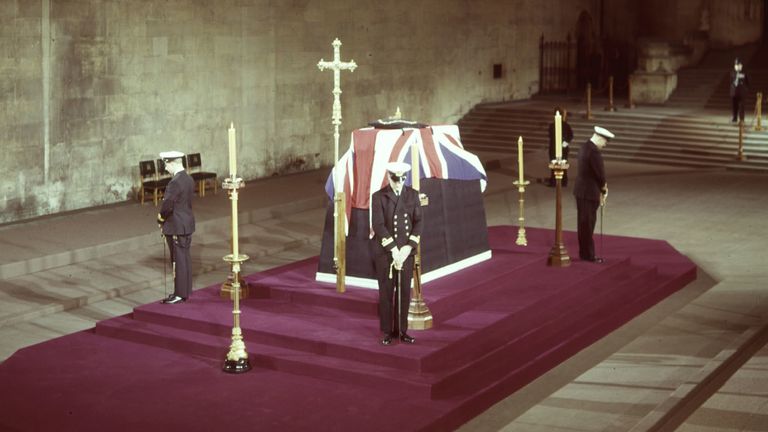 The lying-in-state of Sir Winston Churchill in Westminster Hall. Royal Navy Officers stand guard.