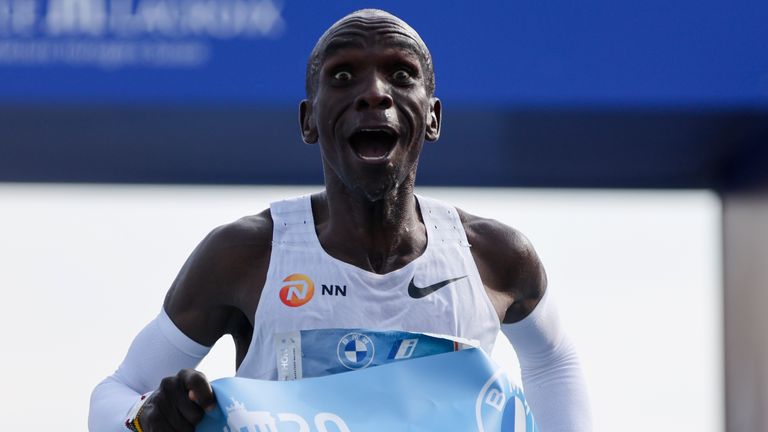 Kenya&#39;s Eliud Kipchoge crosses the line to win the Berlin Marathon in Berlin, Germany, Sunday, Sept. 25, 2022. Olympic champion Eliud Kipchoge has bettered his own world record in the Berlin Marathon. Kipchoge clocked 2:01:09 on Sunday to shave 30 seconds off his previous best-mark of 2:01:39 from the same course in 2018. (AP Photo/Christoph Soeder)