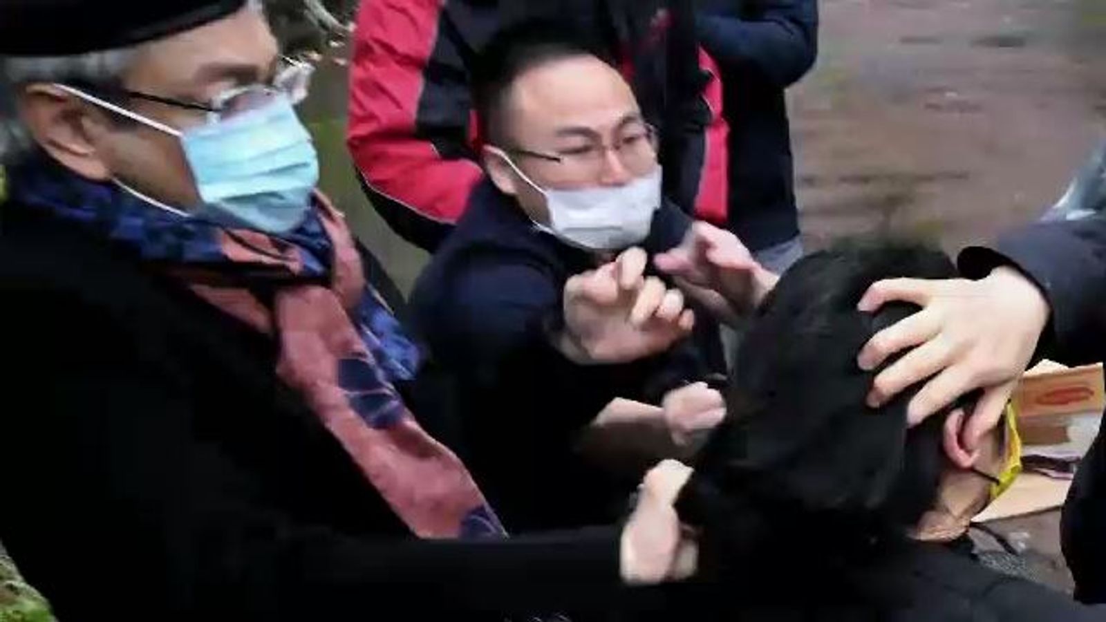 Chinese consul-general defends actions after being seen pulling protester's hair in Manchester 