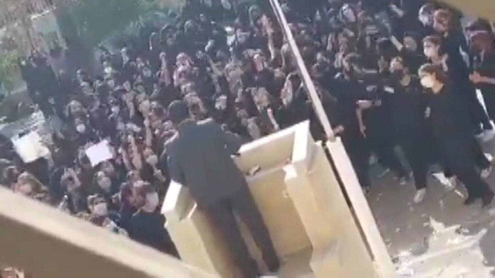Iran: Schoolgirls jeer and heckle paramilitary speaker, waving