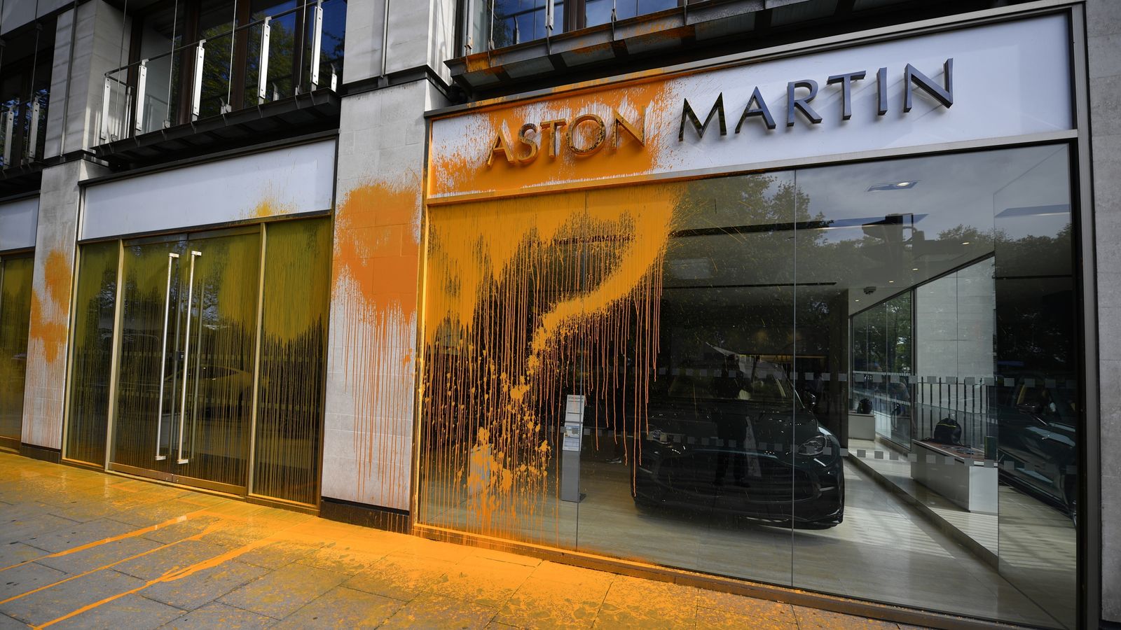 Just Stop Oil protesters spray Aston Martin showroom in London's Park Lane with orange paint