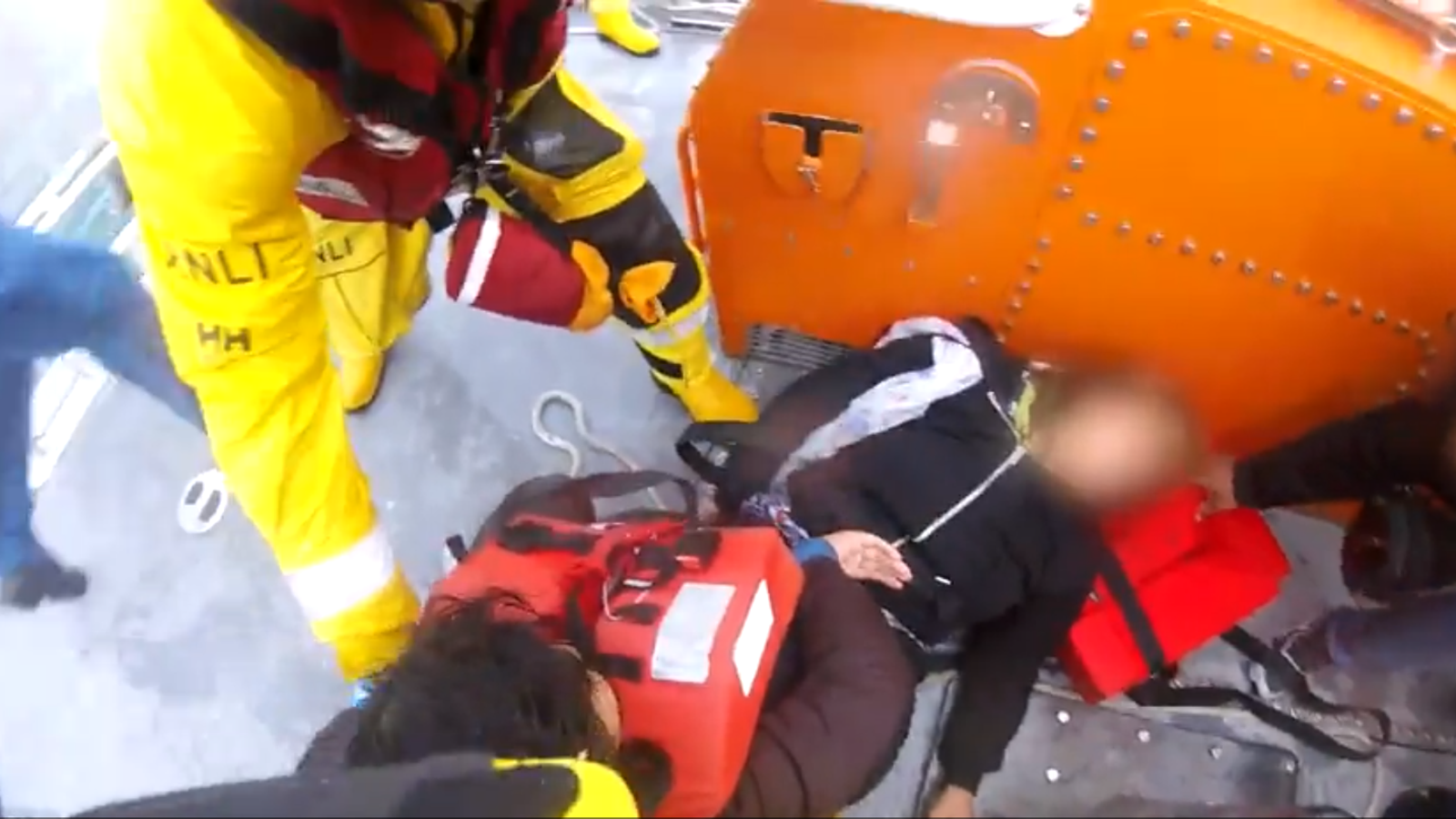 Dramatic footage shows RNLI lifeboat crew pulling family from stricken dinghy in the Channel
