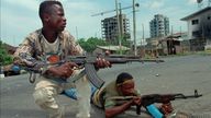 Fighters from the United Liberation Movement of Liberia (ULIMO) shoot their way through downtown Monrovia, LIberia Tuesday, April 16, 1996. Pic: AP