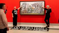 Climate protesters from Extinction Rebellion glued themselves to Picasso&#39;s "Massacre in Korea" at the NGV in Melbourne, Australia October 9, 2022 in this picture obtained from social media. Matt Hrkac/via REUTERS THIS IMAGE HAS BEEN SUPPLIED BY A THIRD PARTY. MANDATORY CREDIT. NO RESALES. NO ARCHIVES.