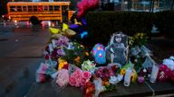 A photo of Alexandria Bell rests at the scene of a growing floral memorial to the victims of a school shooting at Central Visual & Performing Arts High School, Tuesday, Oct. 25, 2022, in St. Louis. Bell and teacher Jean Kuczka were killed, along with the gunman, in Monday's shooting. (Robert Cohen/St. Louis Post-Dispatch via AP)