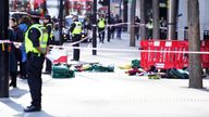 Police officers at the scene after three people have been taken to hospital following reports of stabbings at Bishopsgate in London. Picture date: Thursday October 6, 2022.