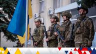Ukrainian troops raising a flag in the city of Lyman