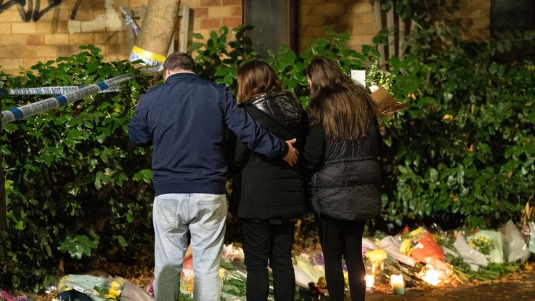 Leah Croucher&#39;s sister Jade Croucher, father John Croucher and Mother Claire Croucher look at flowers outside a property in Loxbeare Drive, Furzton, Milton Keynes, where police have identified human remains during forensic examinations in the search for missing teenager Leah Croucher who disappeared while walking to work in February 2019. Officers from Thames Valley Police began searching the house after a tip-off from a member of the public on Monday, and launched a murder inquiry when they found a rucksack and other personal belongings of Ms Croucher&#39;s. Picture date: Thursday October 13, 2022.