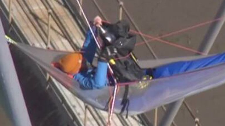 Two climbers who scaled the bridge&#39;s masts at 5am on Monday morning remain there and have vowed to stay until they are forcibly removed.