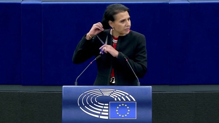 Swedish lawmaker Abir Al-Sahlani cuts her hair as she delivers a speech during EU debate on Iran protests at the European Parliament in Strasbourg, France October 4, 2022 European Union/Handout via REUTERS THIS IMAGE HAS BEEN SUPPLIED BY A THIRD PARTY. NO RESALES. NO ARCHIVES. MANDATORY CREDIT