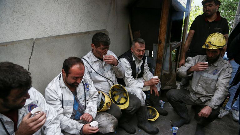 Rescue workers rest outside the coal mine 