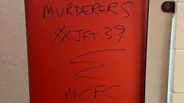 Graffiti pictured in the concourse of the away end at Anfield