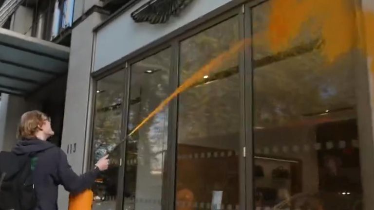 Just Stop Oil activist spray paints Aston Martin showroom