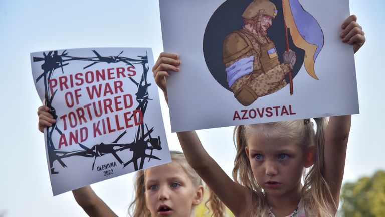 Children hold placards, as relatives and friends of defenders of the Azovstal Iron and Steel Works in Mariupol hold a rally demanding to recognise Russia as a state sponsor of terrorism after killing Ukrainian prisoners of war (POWs) in a prison in Olenivka, outside of Donetsk, as Russia&#39;s attack on Ukraine continues, in Kyiv, Ukraine August 5, 2022. REUTERS/Pavlo Palamarchuk