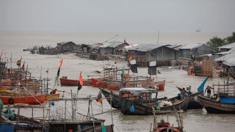 Fishermen on the Bay of Bengal coast guard their boats as they wait out the storm in Patenga, Chittagong, Monday, Oct. 24, 2022. Bangladeshi authorities on Monday evacuated hundreds of thousands of people across the vast coastal region as the tropical storm approached, fearing serious damage.  (AP Photo)