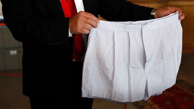 A pair of boxer shorts belonging to Bernard Madoff are displayed by an auctioneer during a media preview of the U.S. Marshals Service 'Madoff II Auction' in the Brooklyn borough of New York November 10, 2010. More than 400 pieces of personal property, jewelry, and antiques from Madoff and his wife, Ruth, will be sold at the auction in New York City on November 13, 2010. The property was forfeited and seized in connection with the criminal prosecution of Madoff by the United States Attorney's Off