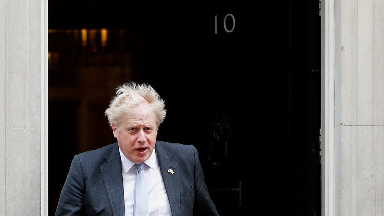 British Prime Minister Boris Johnson walks out of 10 Downing Street to greet Swiss President Ignazio Cassis, in London, Britain, April 28, 2022. REUTERS/Peter Nicholls