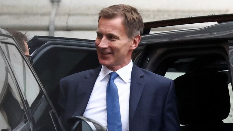 Chancellor of the Exchequer Jeremy Hunt walks outside Downing Street