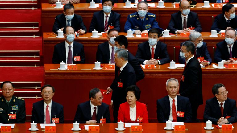 Former Chinese president Hu Jintao leaves his seat during the closing ceremony of the 20th National Congress of the Communist Party of China