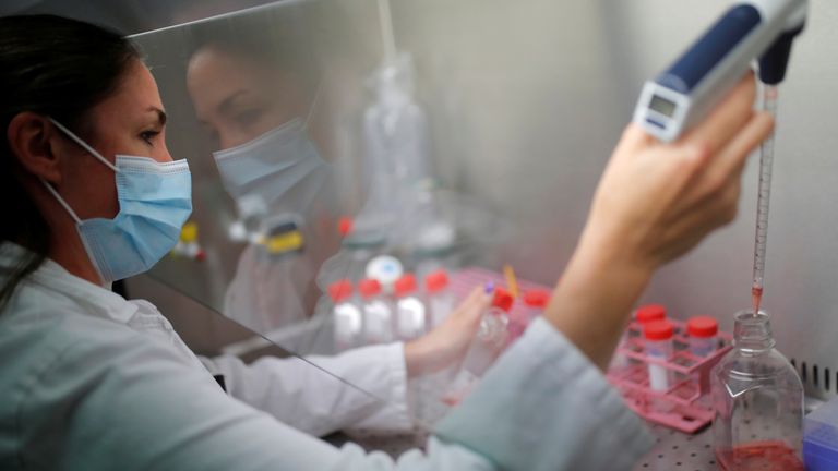 A researcher works on cell culture in a laboratory as part of a project to develop a Covid nasal spray vaccine that could protect against the coronavirus disease (COVID-19), at the University of Tours, France, September 15, 2021. REUTERS/Stephane Mahe